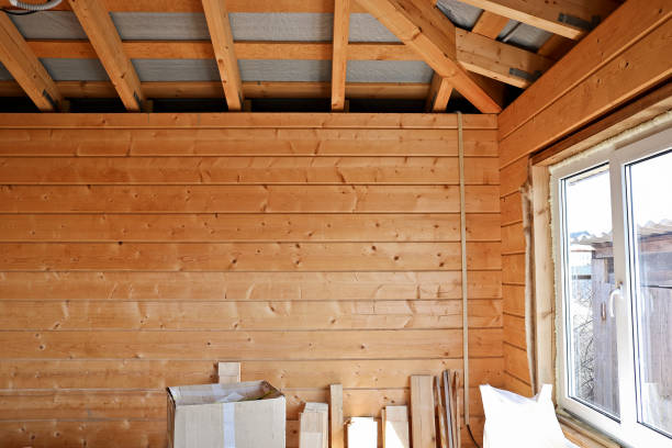 istock Construction and decoration process of a country house, inside view. Wooden wall cladding, building materials on the floor. 1193200212
