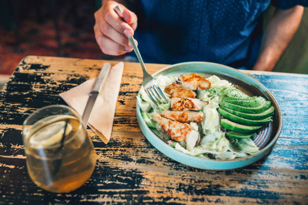 istock Man is eating fresh salad 1193206388