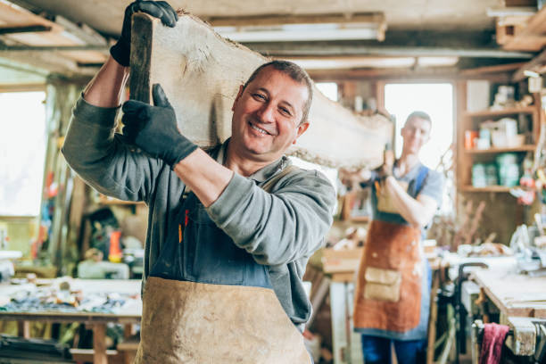 istock Carpenters carrying a wood plank 1193206407