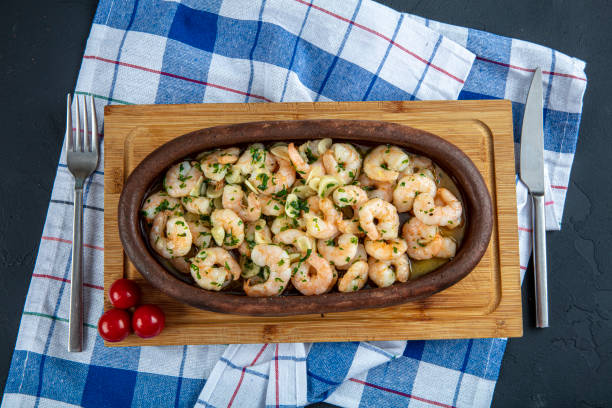 istock Casserole with shrimp on wooden background. 1193206415