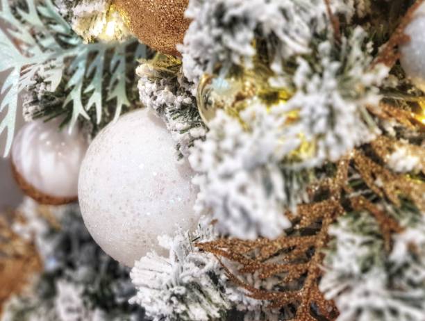 istock Christmas tree covered in snow decorated with beautiful ornaments and lighting. 1193210343