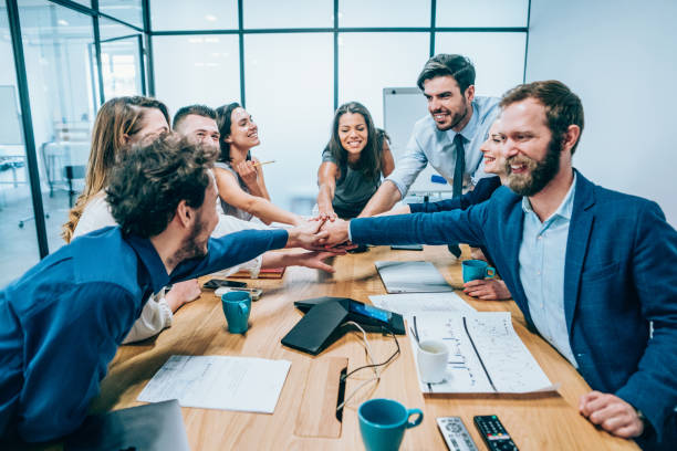 istock Business people stacking hands in conference room 1193214721