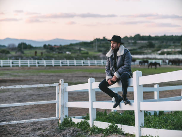 Shot of a young man standing on a farm