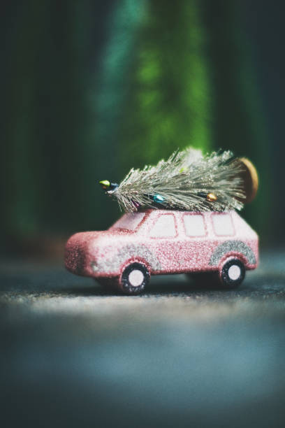 istock Pink car transporting Christmas tree. Christmas holiday background. 1193218515