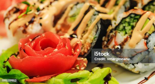 Red Carved Tomato On Background Of Sushi In Sous Restaurant Delicious Dish Decorated In Fancy Style Beautiful Food Decoration Vegetable Flower Holyday Table Stock Photo - Download Image Now