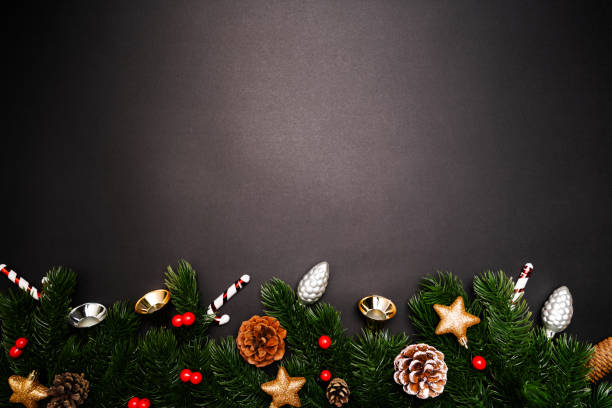 istock Christmas pine tree with xmas decoration on black background 1193225727