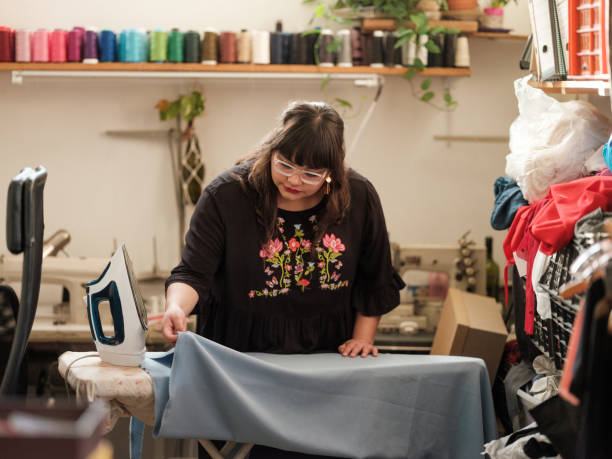 istock Mexican woman ironing fabric in sewing room 1193229486