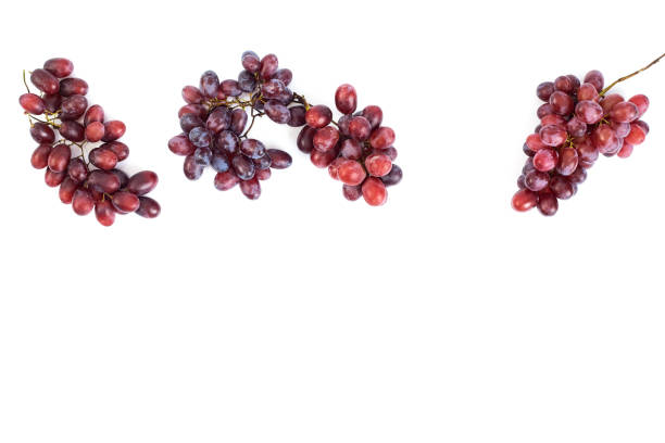Bunch of fresh ripe juicy red grape flat lay on white background, copy space for text