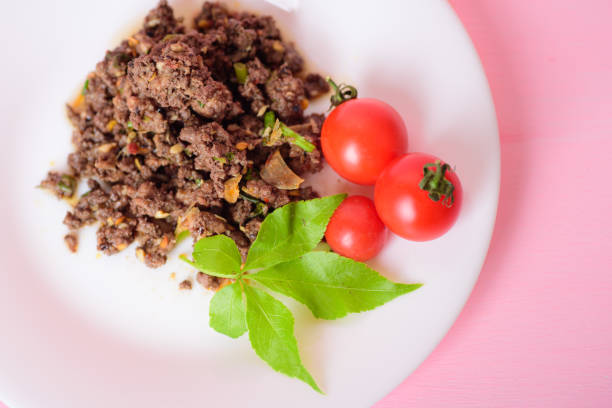 Spicy minced pork (Larb Moo) with fresh tomato, traditional northern Thai food