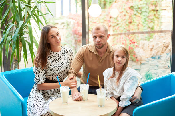 istock Friendly family having milkshakes in the cafe 1193232115