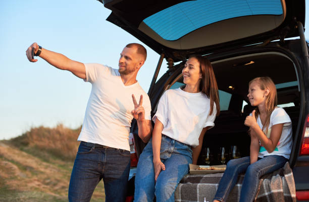 istock Father taking selfie in the car trunk 1193232228