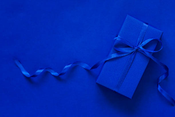 istock Blue gift box with blue bow on dark blue background. Festive concept. 1193235239