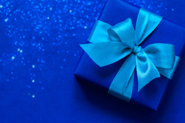 istock Blue gift box with aque mint bow on trendy blue background. 1193235262