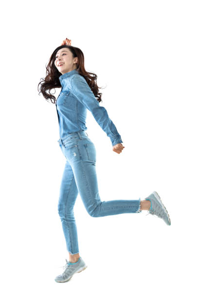 istock Excited woman jumping on white background 1193235945