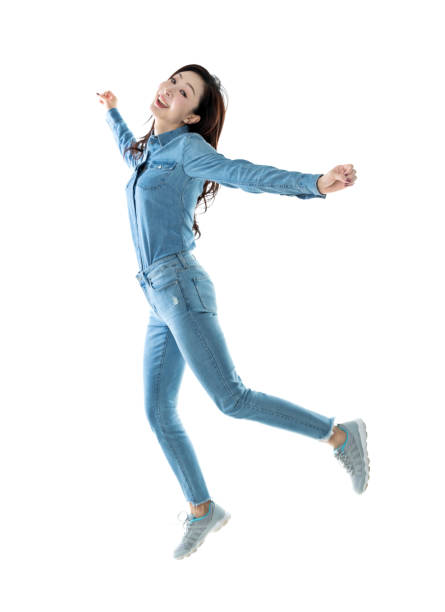 istock Excited woman jumping on white background 1193236025