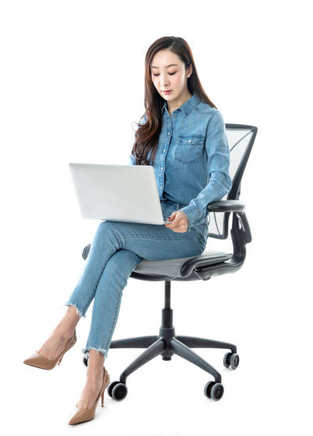 istock Woman sitting on office chair and using laptop 1193236068