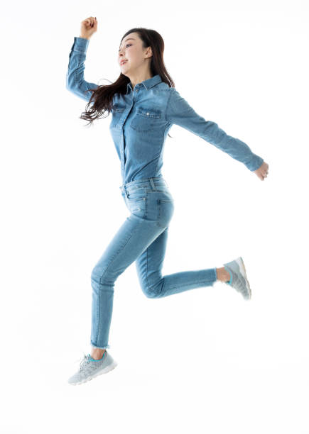 istock Excited woman jumping on white background 1193236261