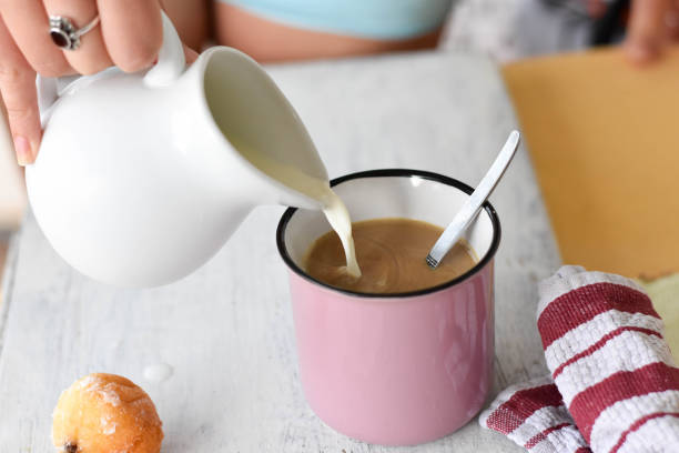 istock Coffee and milk on the table. Pouring milk into coffee/latte/ Breakfast table-starting a day - Image 1193236269