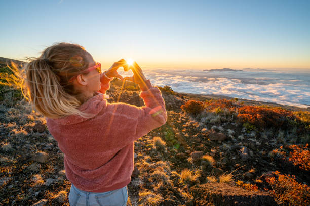 istock Young woman loving sunset above the clouds 1193236317