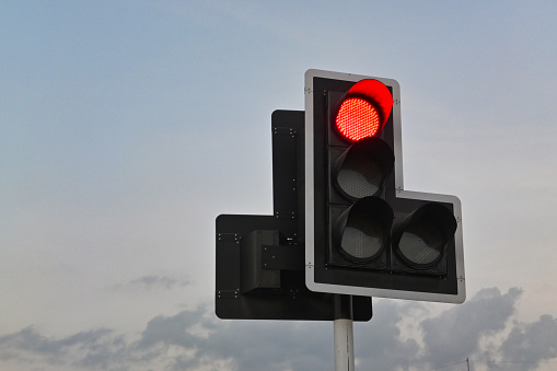 red traffic light with sky background