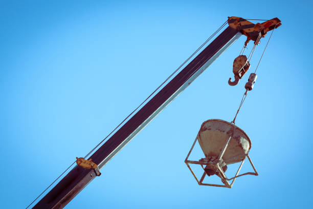 istock machinery crane hoisting cement mortar mixer bucket container in construction site building industry 1193237327