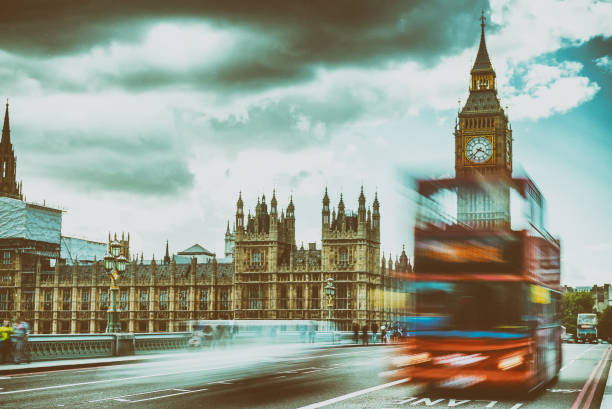 istock Red bus speeding up along Westminster Bridge, blurred view with long exposure 1193237444