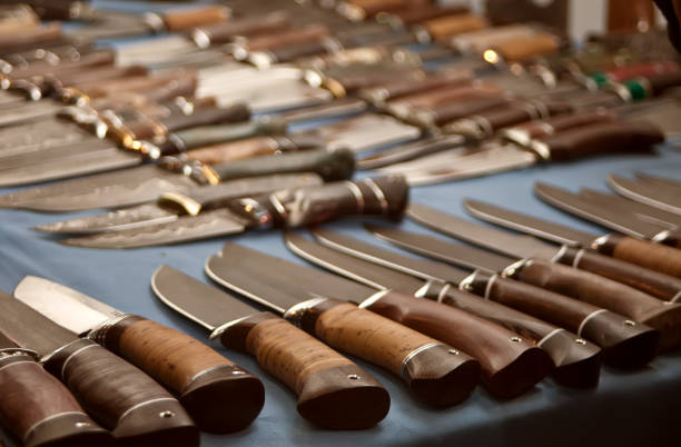 Several in a row of hunting knives. stock photo