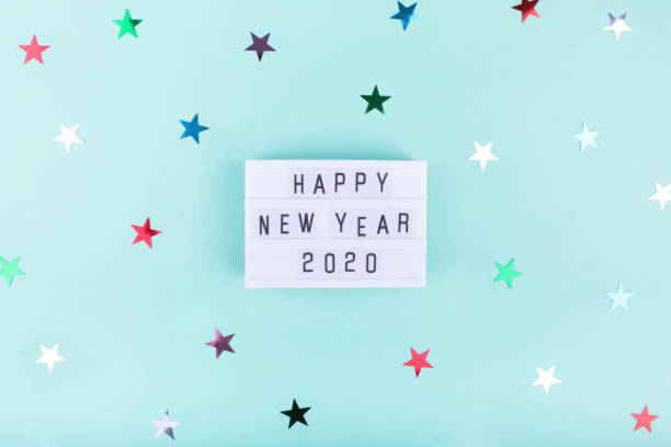 istock Light board with text HAPPY NEW YEAR 2020 on mint color background with stars. 1193238512