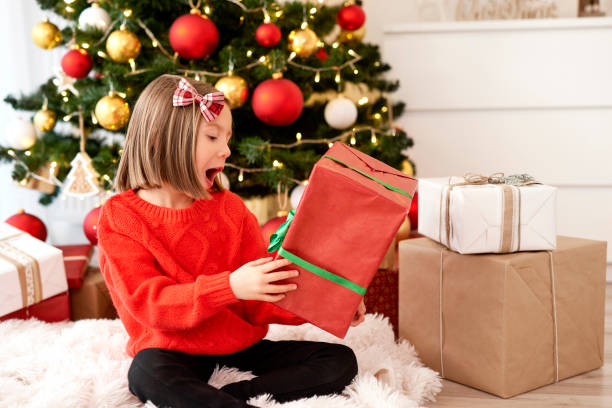istock Excited girl with Christmas gift 1193239123