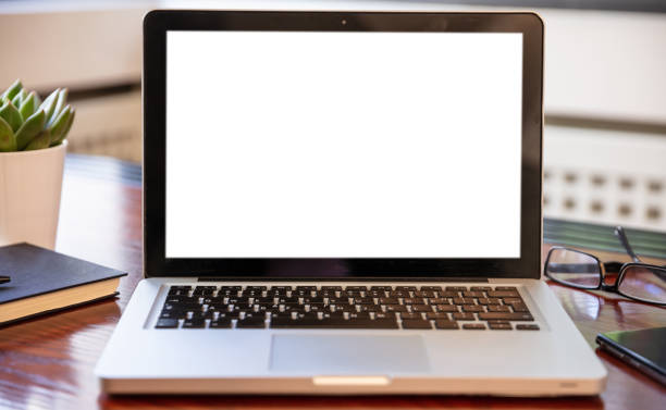 istock Laptop with white blank screen on a wooden desk 1193239310
