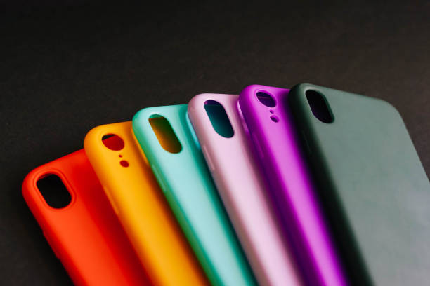 Colorful silicone cases for your smartphone. Yellow, red, purple, lilac, green, mint cases for the smartphone on the black background. Protective silicone cases for smartphone. Set of colored silicone covers for smartphone. Selective focus. personal accessory stock pictures, royalty-free photos & images