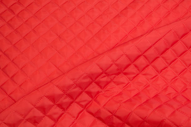 istock Quilted fabric. The texture of the blanket.Red textile 1193240278