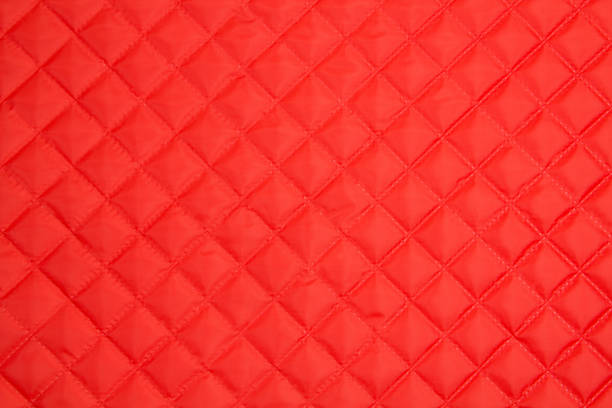 istock Quilted fabric. The texture of the blanket.	Red textile 1193240309