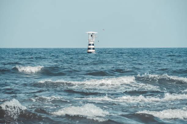 istock Lighthouse on the sea with Thailand flag. 1193242440