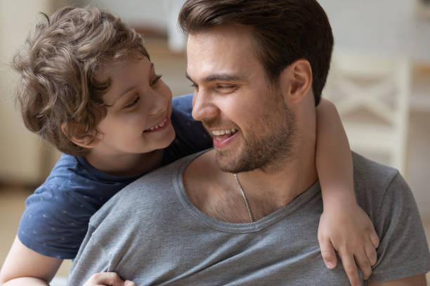 istock Happy father carrying little son on back, hugging, having fun 1193245271