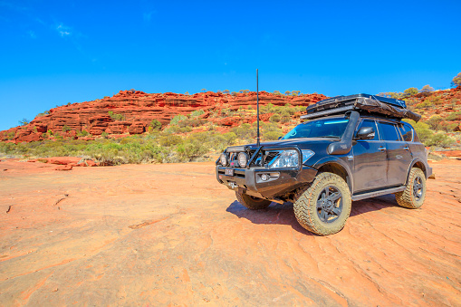 Finke Gorge National Park, Northern Territory, Australia - Aug 19, 2019: perspective view of full 4X4 vehicle at Palm Valley in Central Australia Outback. Discovery and adventure travel concept.