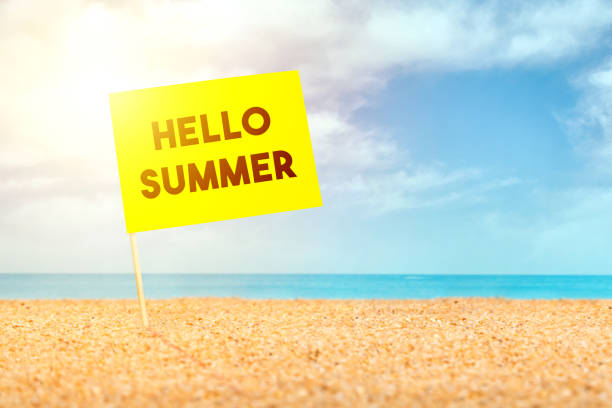 istock Post it with hello summer words, it stands on the sand at the beach 1193248451
