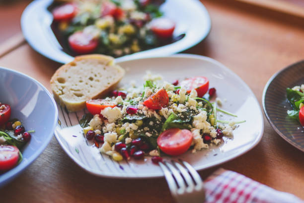 istock Arugula salad with soft cheese, sweetcorn, pomegranate and cherry tomatoes 1193249527