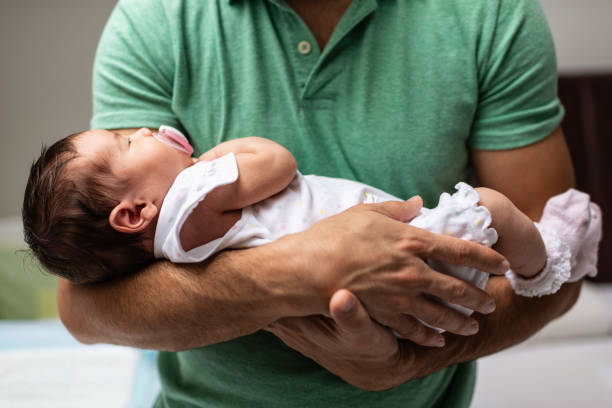 istock Father holding newborn baby 1193250112