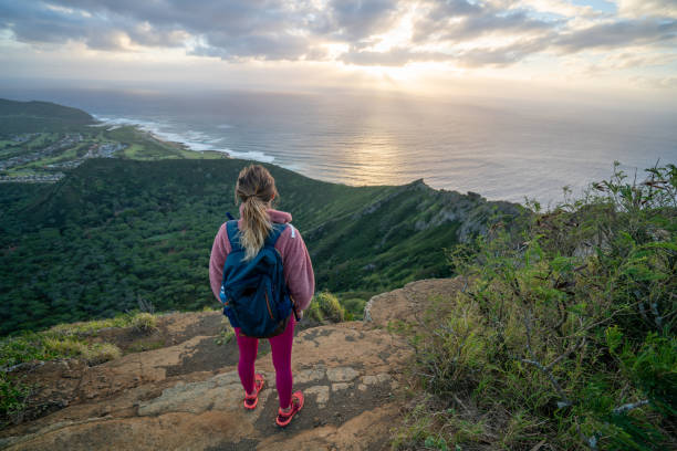 istock Hiker woman on mountain top at sunrise 1193250366