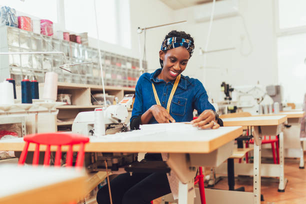 istock Dressmaker woman working with sewing machine 1193252480