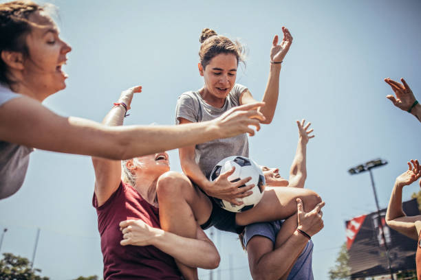 Female soccer players celebrating victory together Group of women, female soccer players together outdoors, celebrating victory. football player girlfriend stock pictures, royalty-free photos & images