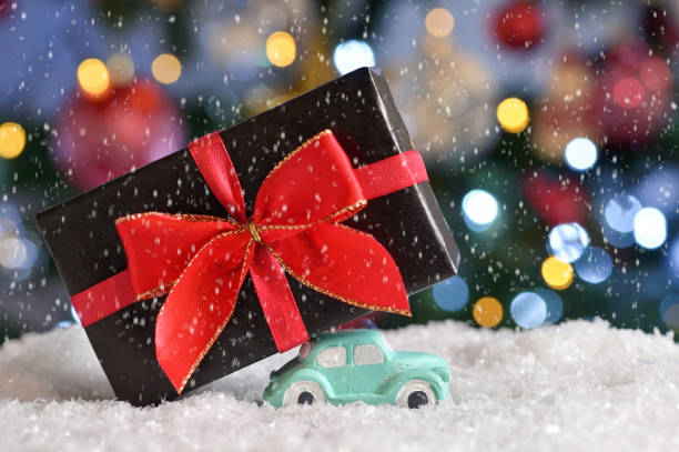 istock Car Toy Carrying A Christmas Gift 1193254422
