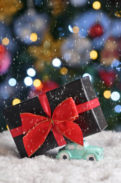 istock Car Toy Carrying A Christmas Gift 1193254424