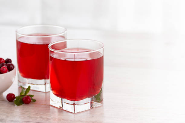 glass with fresh organic cranberry juice. - cranberry juice imagens e fotografias de stock