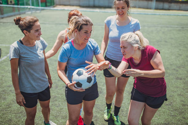 Female soccer players outdoors on soccer field Group of women, female soccer players together outdoors on soccer field. football player girlfriend stock pictures, royalty-free photos & images