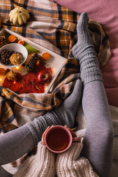 istock Holding a warm cup of tea and relaxing in bed 1193256492