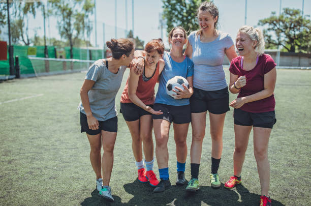 Female soccer players outdoors Group of women, female soccer players together outdoors on soccer field. football player girlfriend stock pictures, royalty-free photos & images