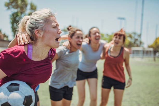 Happy female soccer players outdoors Group of women, female soccer players together outdoors on soccer field. football player girlfriend stock pictures, royalty-free photos & images