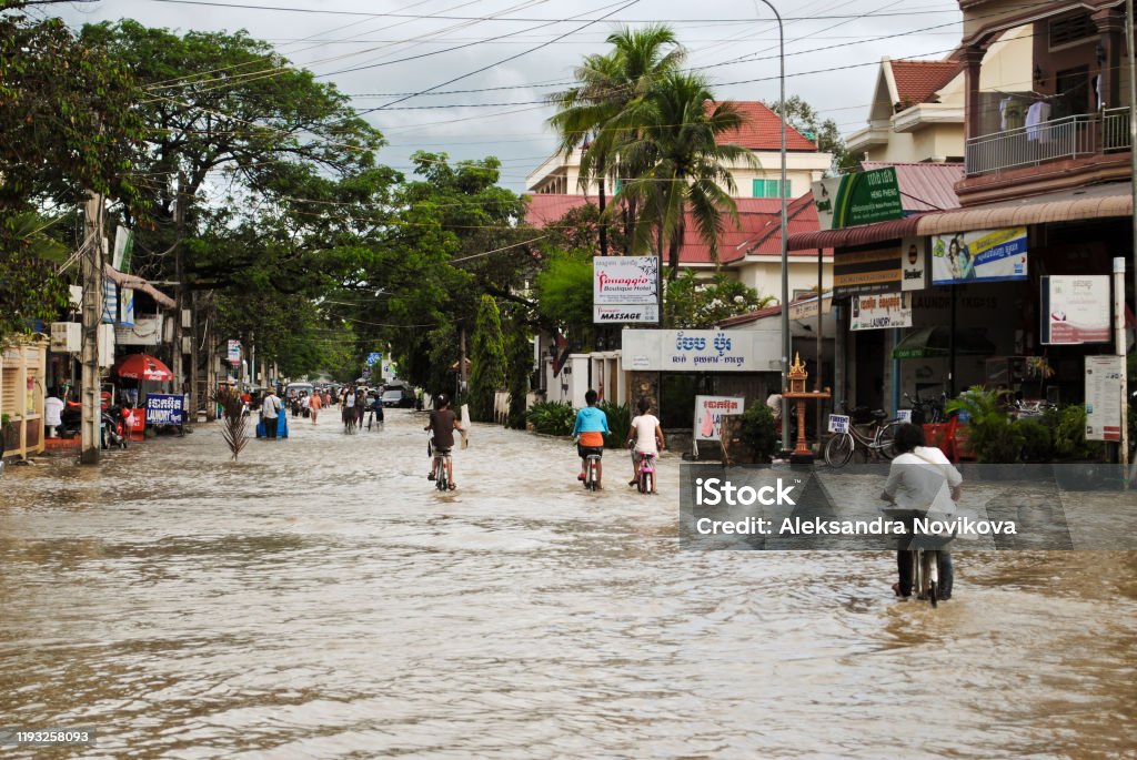 Flooding in the streets of Cambodia The daily life of the local people against flooding in the streets of Cambodia Flood Stock Photo